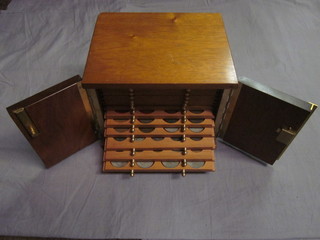 A wooden coin collectors cabinet fitted 14 various drawers and contents of coins