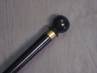 An ebony walking cane with gold band