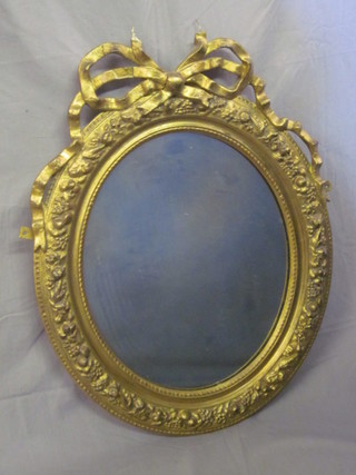 A circular plate mirror contained in a decorative gilt frame with  swag decoration 26"