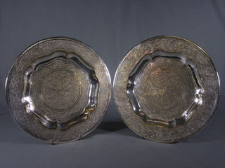 A pair of circular engraved Indian silver plated dishes 11"