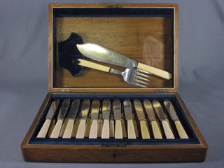 A canteen of 12 silver plated fish knives and forks contained in  an oak box