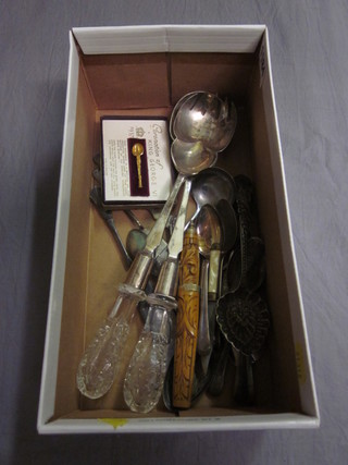 A pair of silver plated salad servers with cut glass handles and a small collection of flatware
