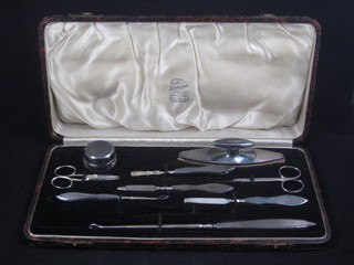 A silver handled manicure set, cased