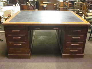 A Victorian mahogany kneehole pedestal partners desk with inset tooled leather writing surface, the pedestals fitted 16 drawers 65"