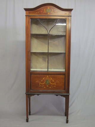 An Edwardian arch shaped inlaid mahogany display cabinet fitted  shelves enclosed by an astragal glazed panelled door, raised on  square tapering supports ending in spade feet 27"