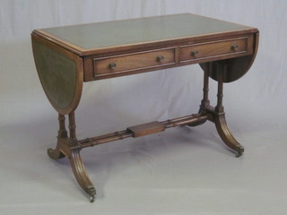 A Georgian style mahogany sofa table with inset green leather writing surface, fitted 2 long drawers, raised on a turned column  39"