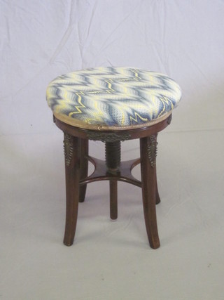 A Victorian mahogany revolving adjustable piano stool