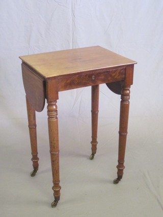 A 19th Century rectangular mahogany work table, fitted a drawer  with flaps to the side, raised on turned supports 19"