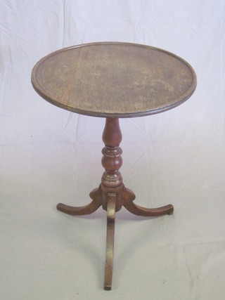 A circular oak wine table, raised on a turned yew column with tripod base, some old worm to base, 19"