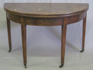 A Georgian mahogany demi-lune tea table inlaid shell decoration, raised on chamfered supports, 45"