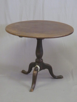 A circular mahogany snap top wine table, raised on pillar and  tripod supports 30"