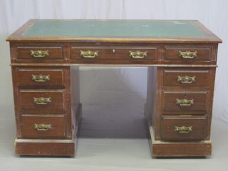 An Edwardian walnut kneehole pedestal desk with inset tooled writing surface, above 1 long and 8 short drawers 48"