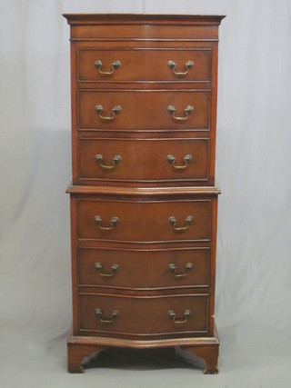 A Georgian style mahogany miniature chest on chest of  serpentine outline, both sections fitted 3 long drawers, raised on  bracket feet 22"