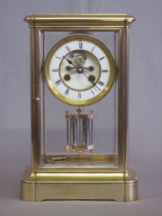 A Victorian 4 glass mantel clock contained in a gilt case with enamelled dial, Roman numerals and visible escapement