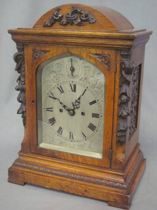 A Victorian striking fusee bracket clock with 6 1/2" arch silvered dial having Roman numerals, strike/silent indicator, contained in  an arched heavily carved oak case, raised on bracket feet 13"   ILLUSTRATED