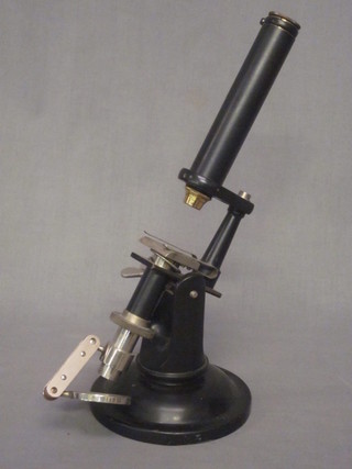 A black metal single pillar microscope marked C.I. Co Ltd