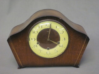 A 1950's chiming mantel clock with Arabic numerals contained  in an arch shaped oak case by Smiths