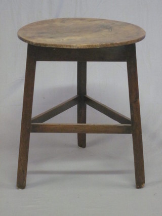 A 19th Century circular elm cricket table, raised on square supports 19"
