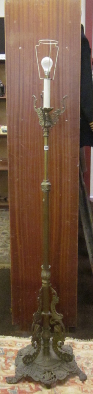 A reeded brass electric standard lamp