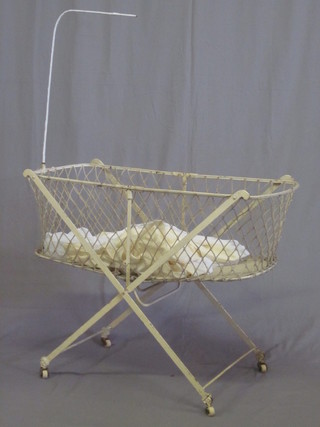 A Victorian oval iron childs crib complete with drapes 40"