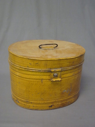 An oval pressed metal hat box