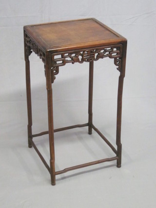 An Oriental square padouk occasional table with pierced apron, raised on turned supports 15"