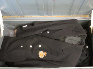 A uniform trunk containing a Royal Artillery battle dress blouse,  various bush shirts, 2 blazers etc