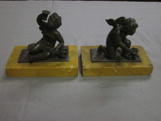 A pair of 19th Century bronze figures of kneeling and seated putti, raised on yellow marble bases 5", 1f,