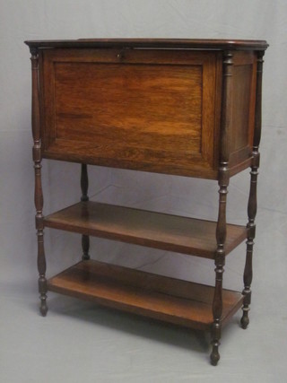 A Victorian rosewood escritoire, the fall front revealing a fitted interior, the base fitted 2 shelves raised on turned supports 32"
