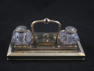 A 19th Century rectangular brass twin compartment standish with stamp box to the centre, flanked by a pair of cut glass  inkwells 9"