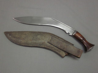 A Kukri, the 12" blade marked EM complete with leather  scabbard