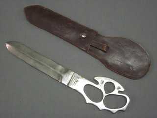 A Jodhpur City Volunteer Corps double bladed fighting knife incorporating a knuckle duster, the grip marked Jodhpur City  Volunteer Corps Jodhpur April 22nd 1951, complete with leather  scabbard