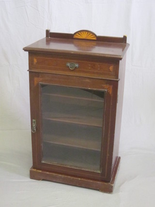 An Edwardian mahogany music cabinet with raised back, the  base fitted a drawer above a cupboard enclosed by glazed  panelled door 23"