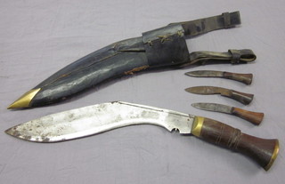 A Kukri with 11" blade complete with scabbard and 3 skinning  knives