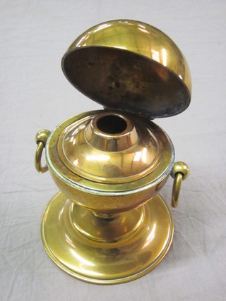 A brass globular shaped twin handled inkwell with hinged lid 3"