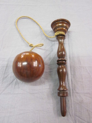 A childs 19th Century turned wooden cup and ball game