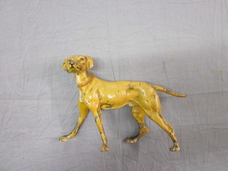 A painted metal figure of a standing dog