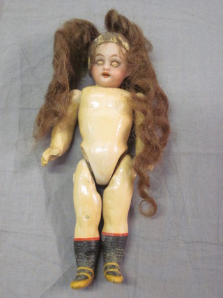 A 19th Century miniature porcelain headed doll with open and  shutting eyes and articulated limbs 4 1/2"