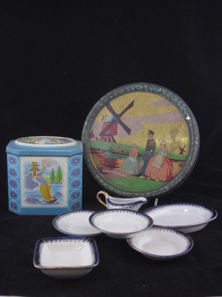 A 1930's circular biscuit tin decorated a Dutch scene containing a childs 6 piece doll house dinner service comprising 4" meat  plate, 2" bowl, 3 plates 3" - 1 chipped, and a sauce boat,  together with a metal tea caddy containing various beads