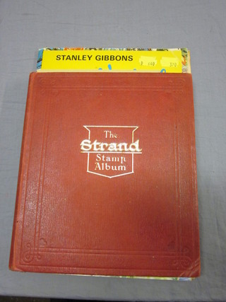 A red Standard stamp album and a Stanley Gibbon Gay Venture stamp album