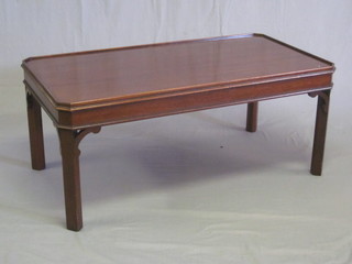 A Chippendale style lozenge shaped mahogany coffee table,  raised on square supports 42"