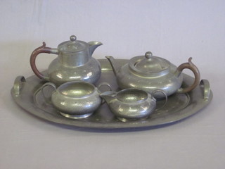 An Art Nouveau English planished pewter 5 piece tea service  comprising oval twin handled tray, teapot, hotwater jug, cream  jug and sugar bowl