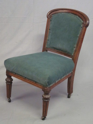 A Victorian show frame mahogany dining chair upholstered in  blue material, raised on turned and fluted supports