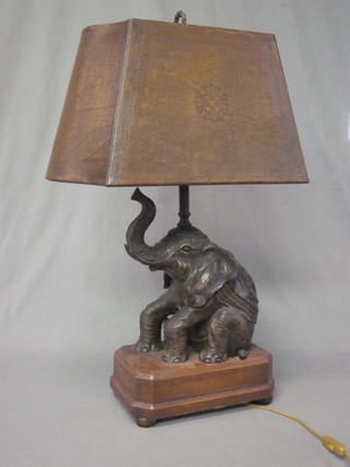 A bronze table lamp in the form of a seated elephant 15"