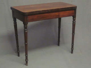 A 19th Century mahogany D shaped tea table, raised on turned supports 34"