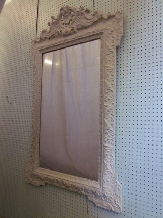A rectangular bevelled plate mirror contained in a decorative  white plaster frame 47" x 28"
