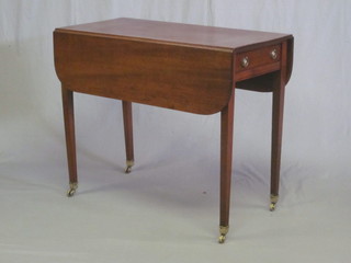 A 19th Century mahogany Pembroke table fitted a frieze drawer  and raised on square tapering supports ending in brass caps and  castors 36"