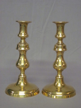 A pair of 19th Century circular brass candlesticks with ejectors 9  1/2"