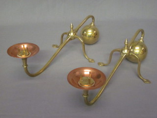 A pair of copper and brass pricket style candlesticks in the form of fire dogs marked WAS Benson
