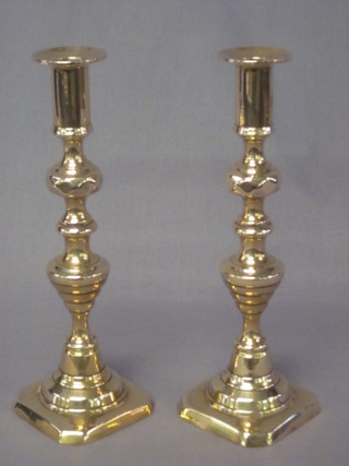 A pair of Victorian brass candlesticks with knopped stems 11"